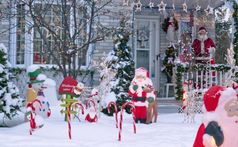 A front porch of the house decorated with candy canes and Santa