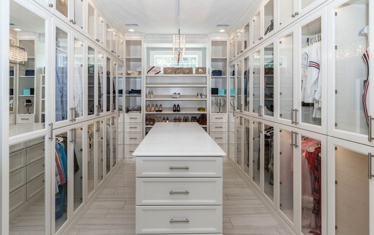 A custom-designed closet with a white theme