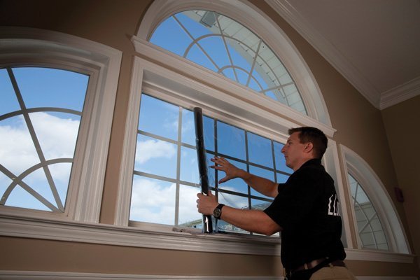 An LHS representative installing a solar reflective film.