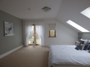 A bedroom window with vertical blinds.