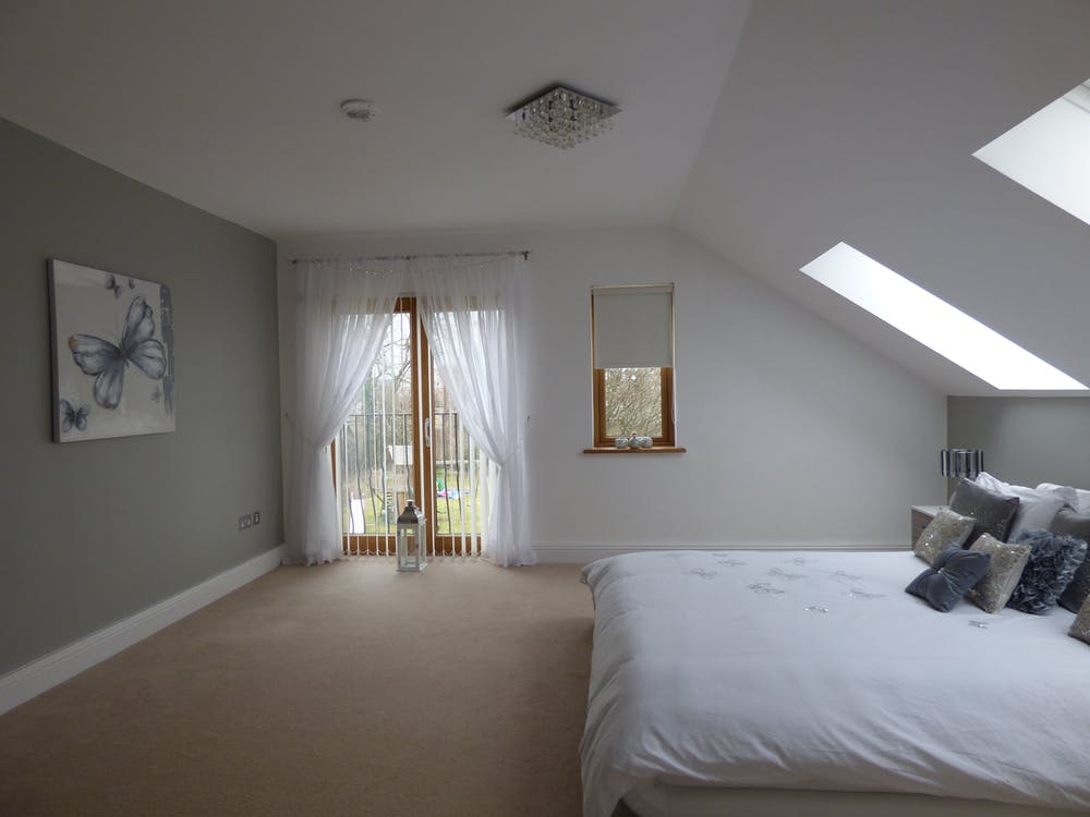 A bedroom window with vertical blinds.