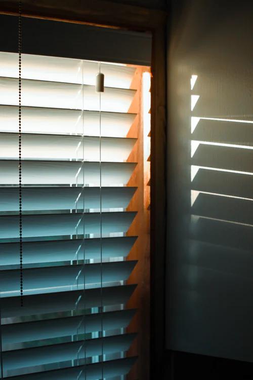 a close up of fauxwood blinds